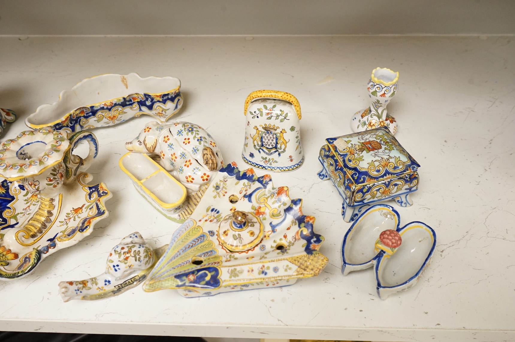 A group of French faience pottery to include spill vases, an ink well and dishes, largest 21cm high